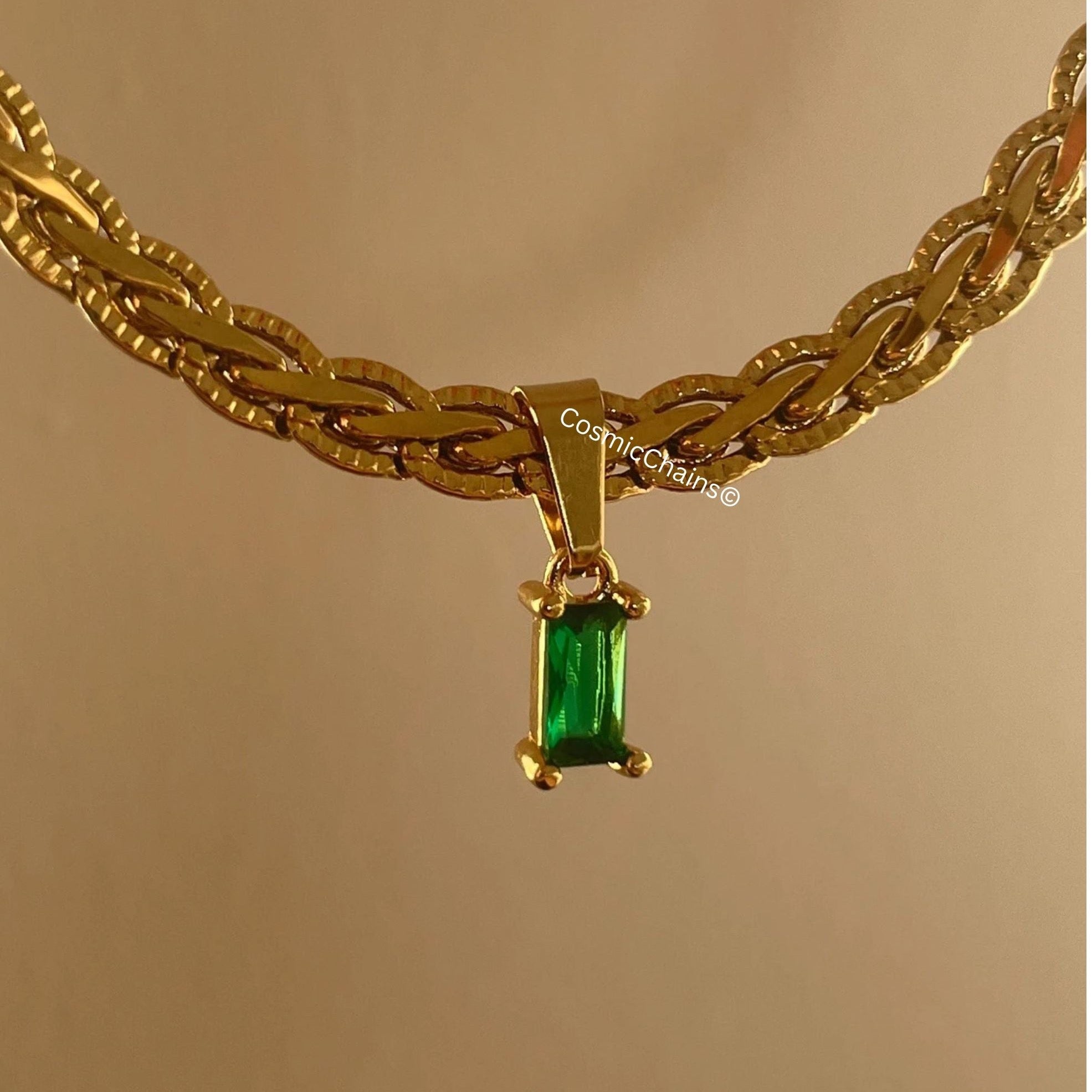 Elegant gold necklace with small green pendant detail