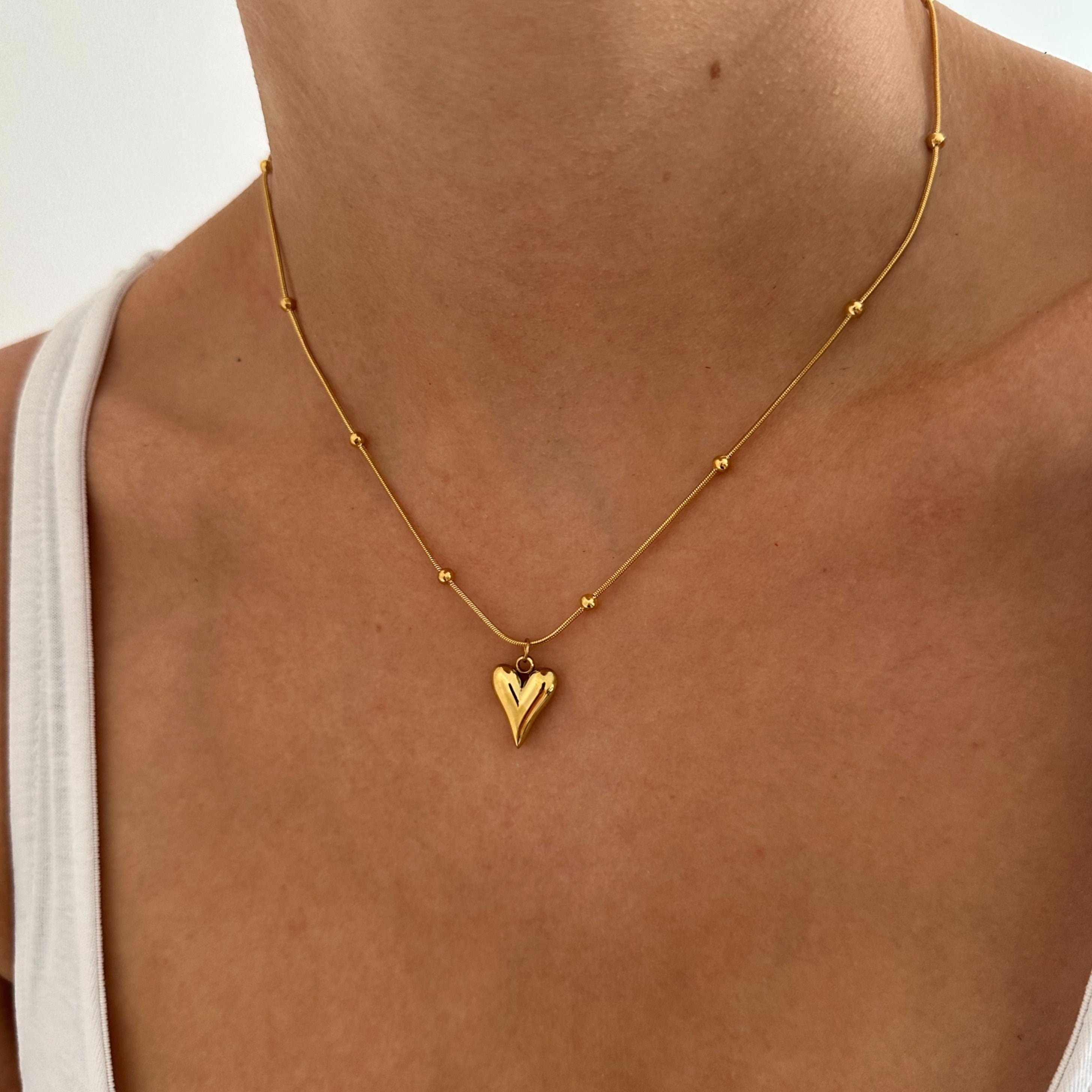 Golden Heart Pendant Necklace - A stylish and versatile accessory that effortlessly elevates any outfit, making a bold statement with its understated beauty