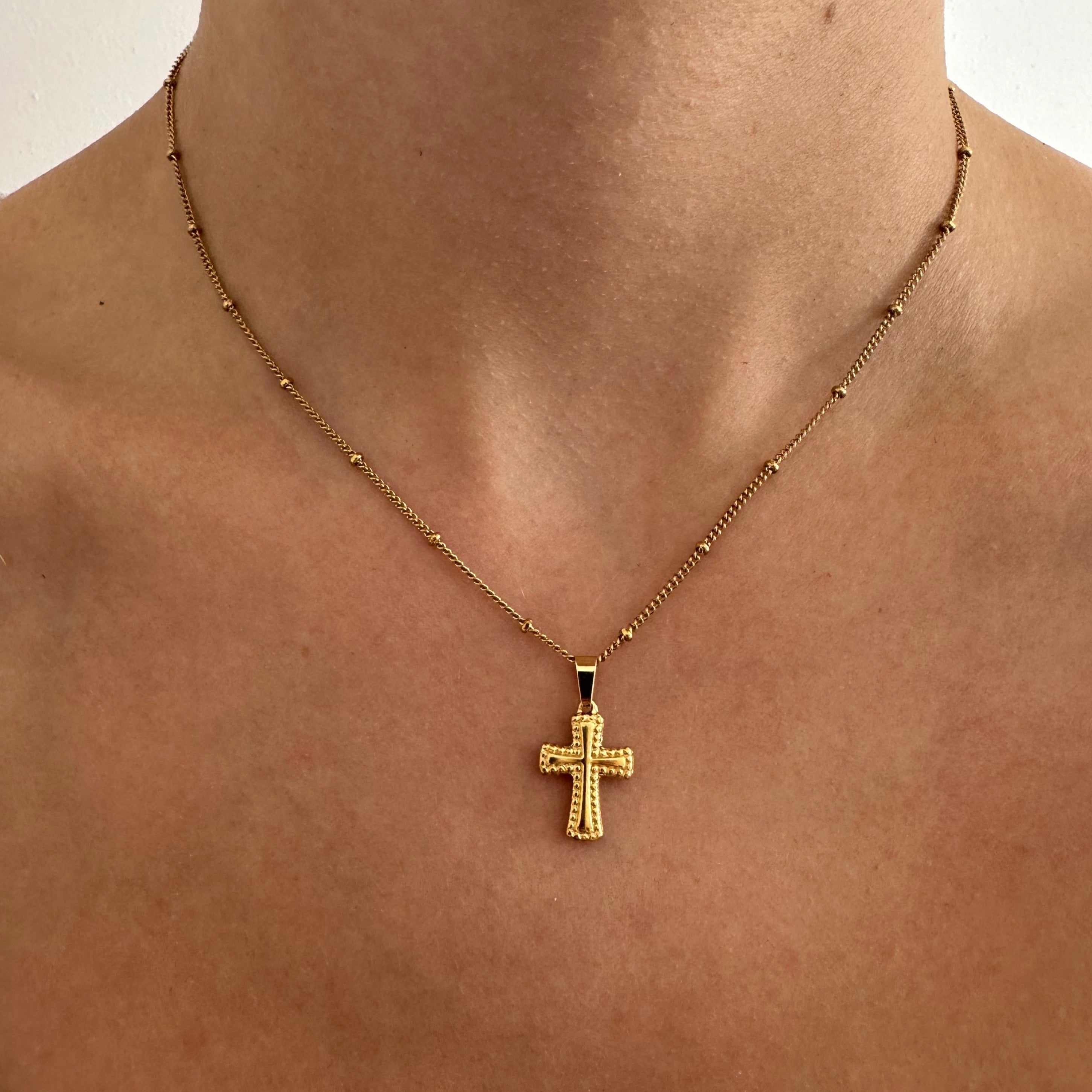 Gold Cross Necklace - Elegant jewelry accessory for women, featuring a stylish cross pendant on a gold chain.