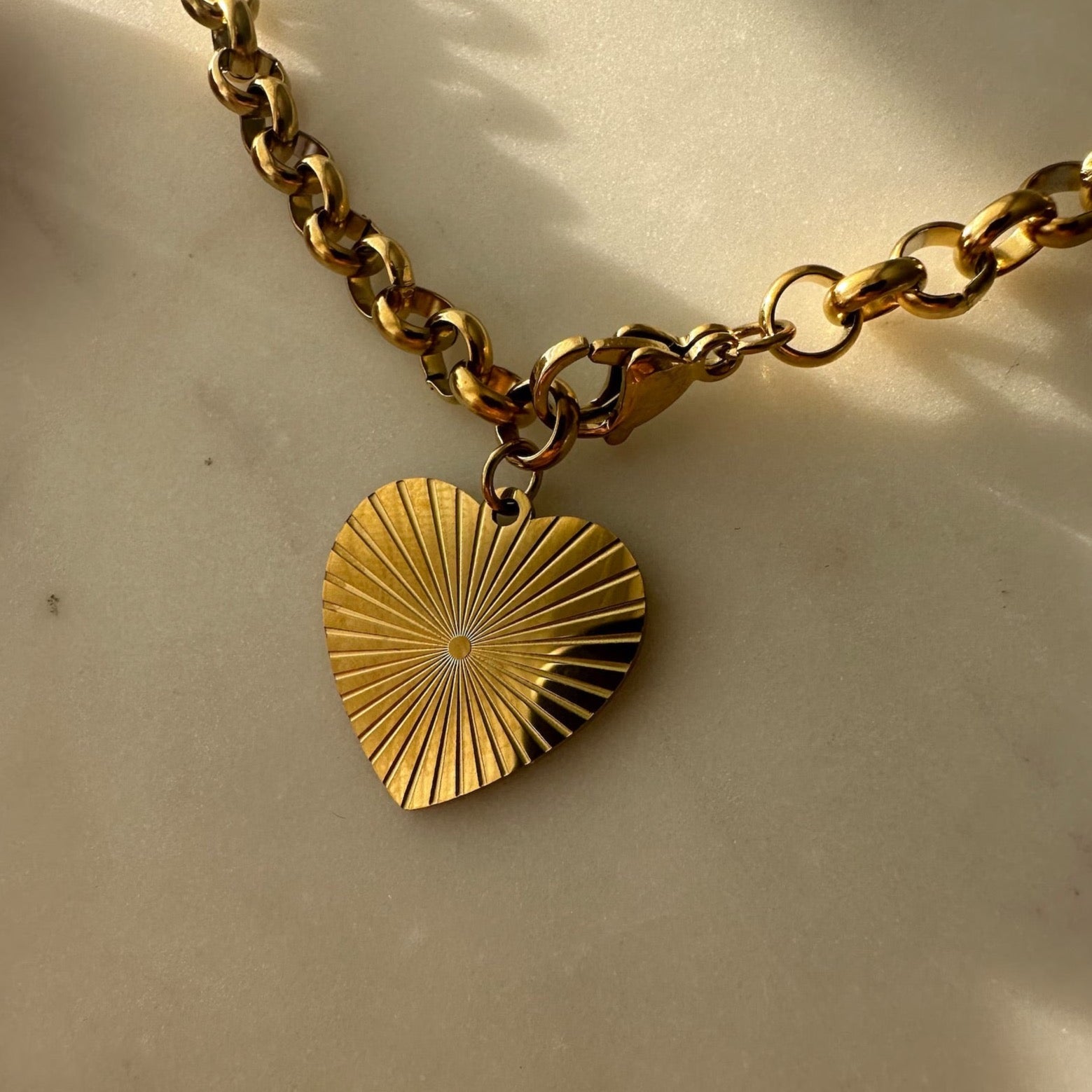 Heart chain necklace adorned with a shimmering golden heart