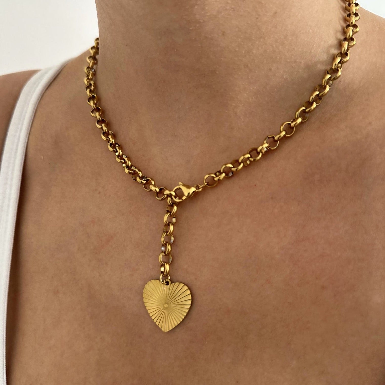 Heart Pendant Necklace complementing a beautiful gold chain