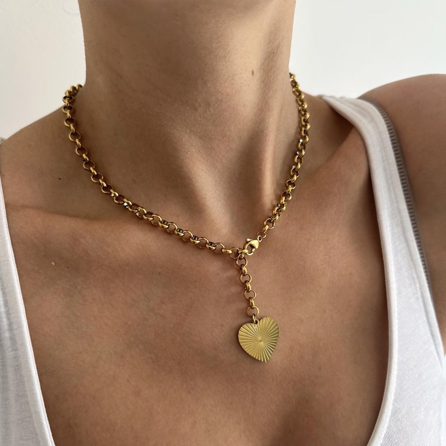Gold Chunky Heart Necklace gleaming on a delicate chain