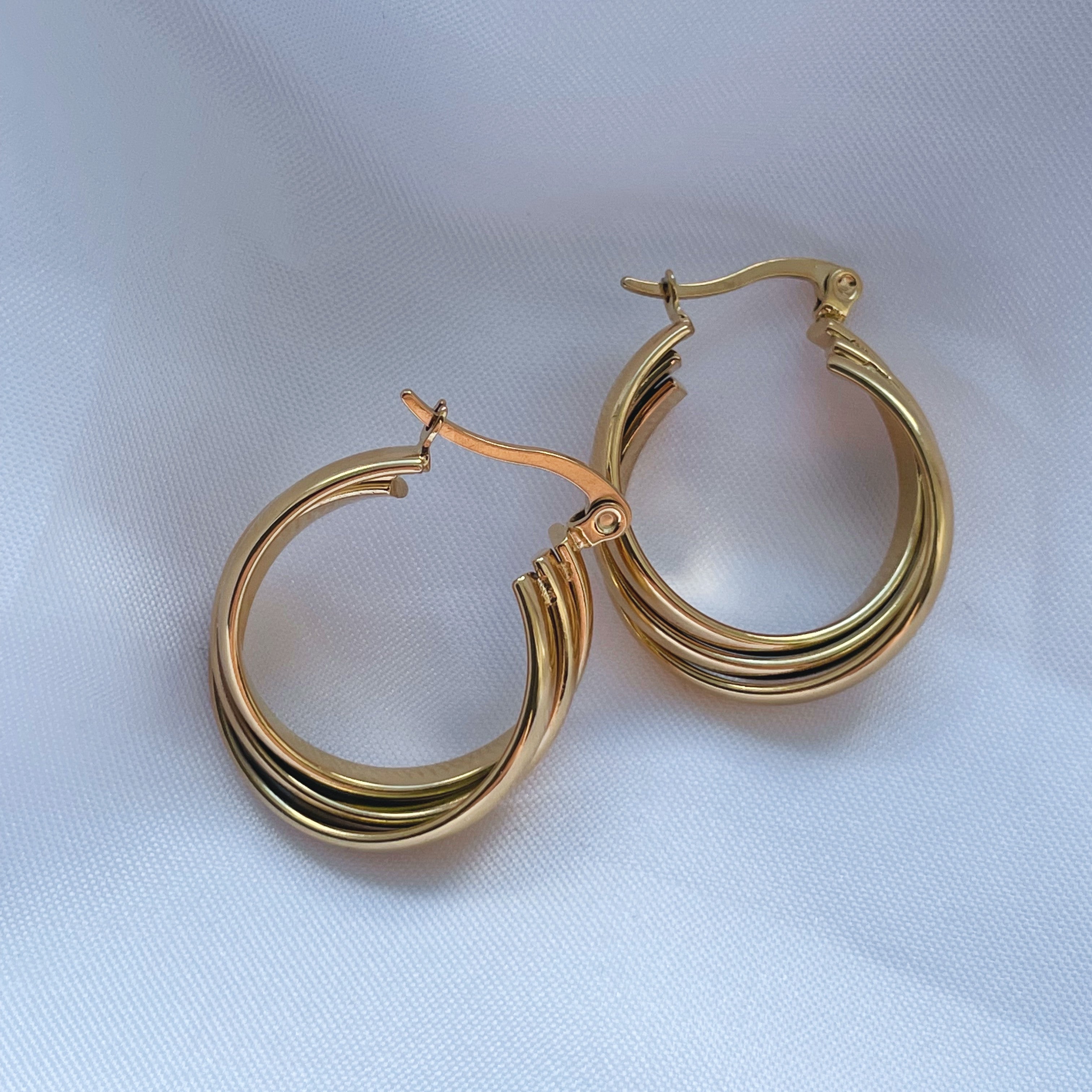 "Accessorise with flair using our Golden Twirl Gold Twist Hoops