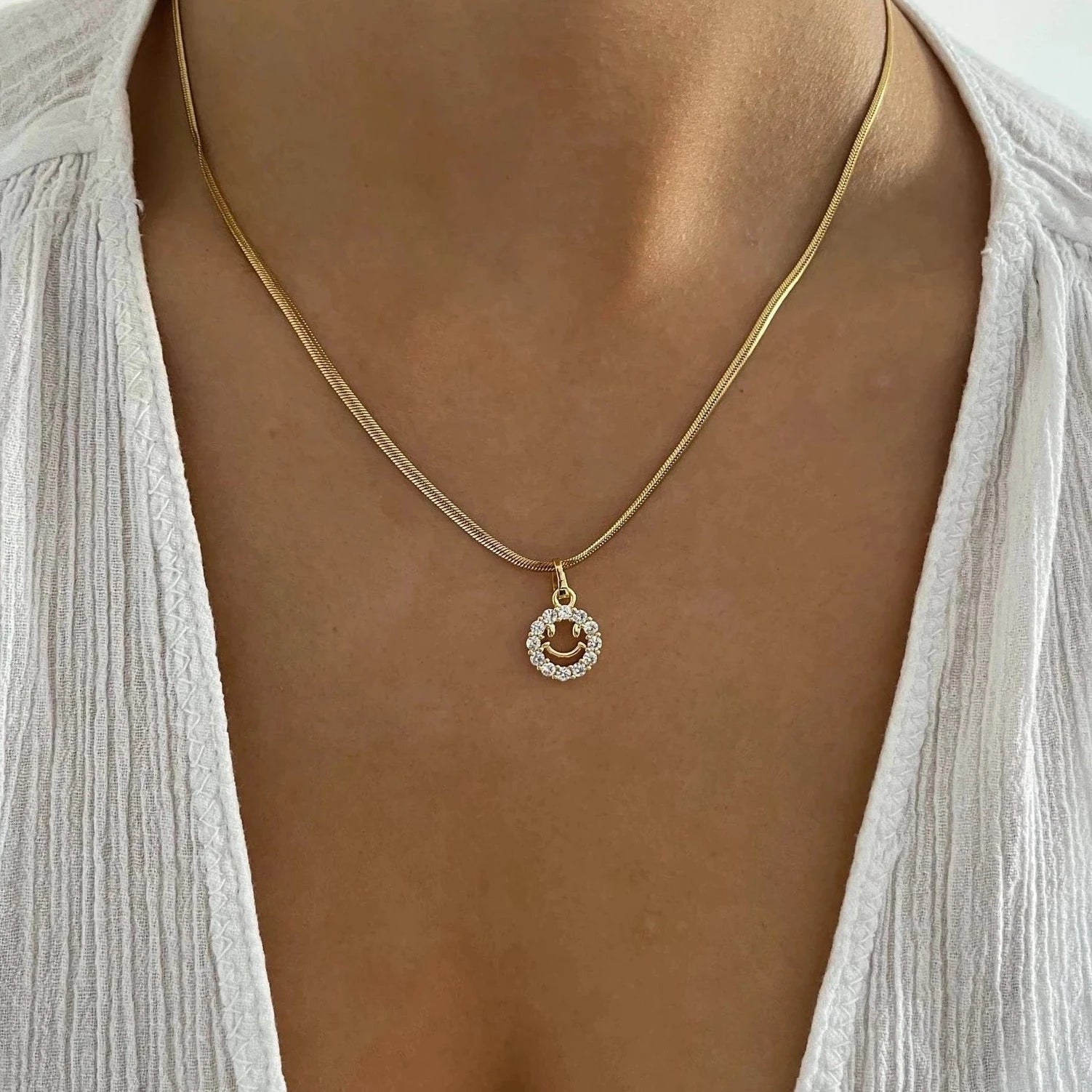 Chic gold smiley face necklace for a trendy look.