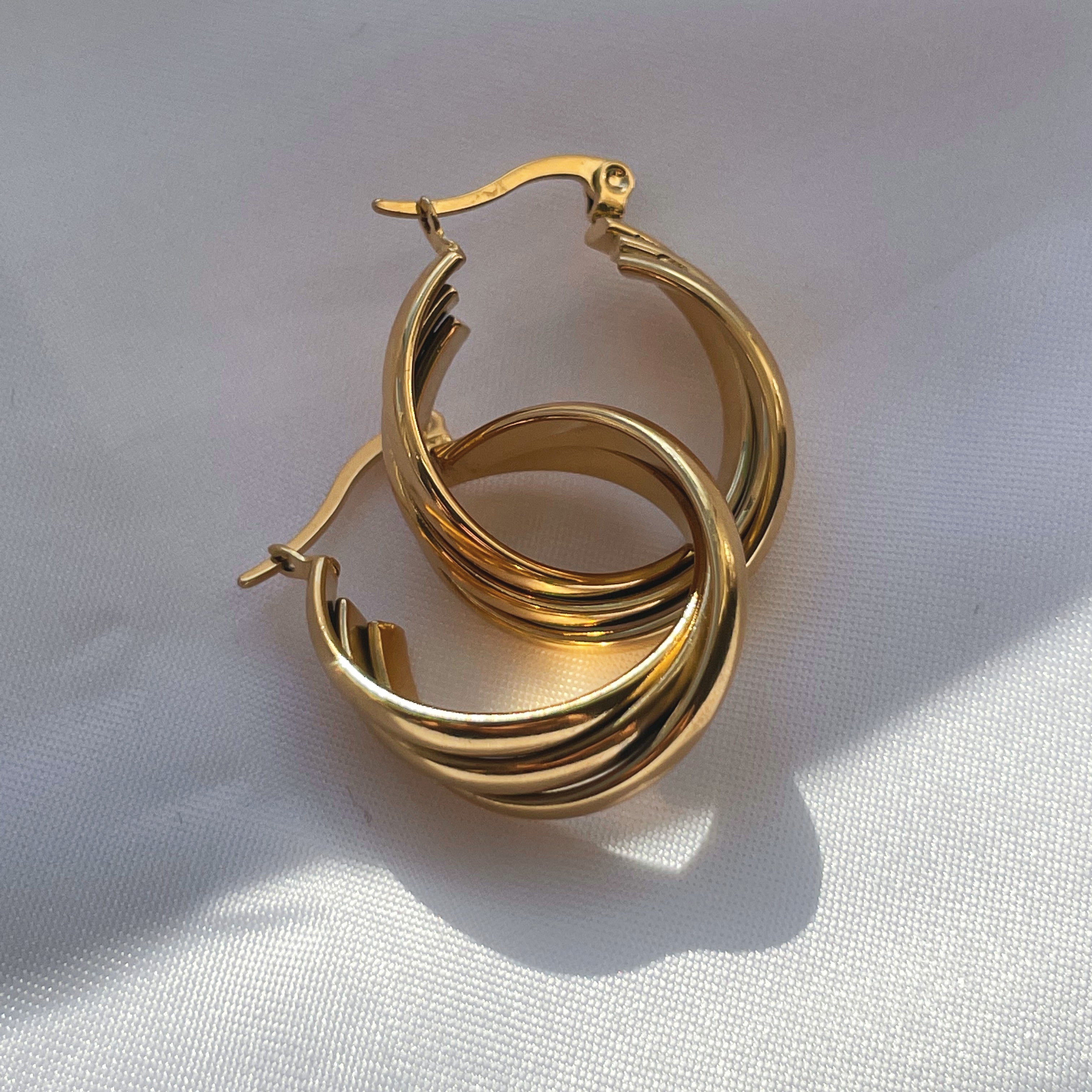 Chic and stylish Gold Twist Hoops adding flair to any outfit