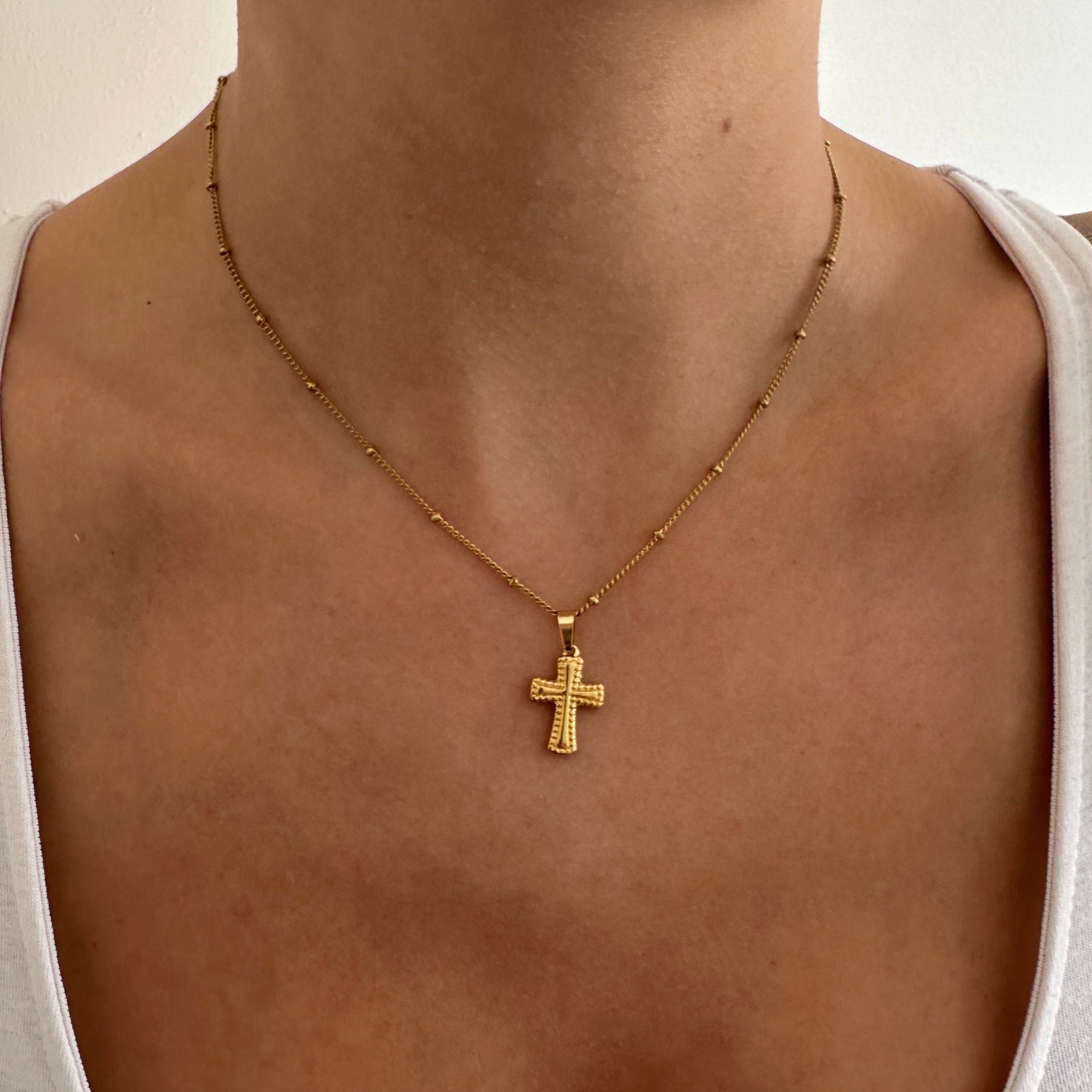Woman Wearing Gold Cross Necklace with Confidence - Empower your style with this stunning and meaningful piece