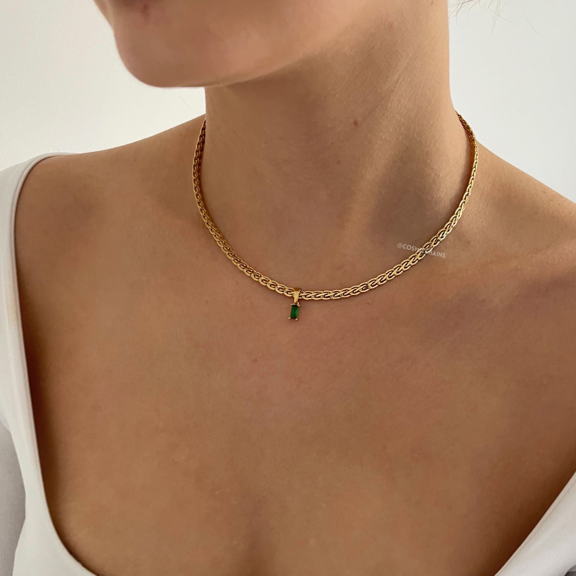 Classy jewelry piece: gold necklace adorned with green charm 