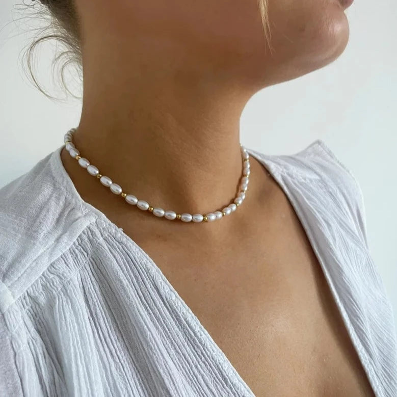 Indulge in the allure of a gold and pearl necklace.